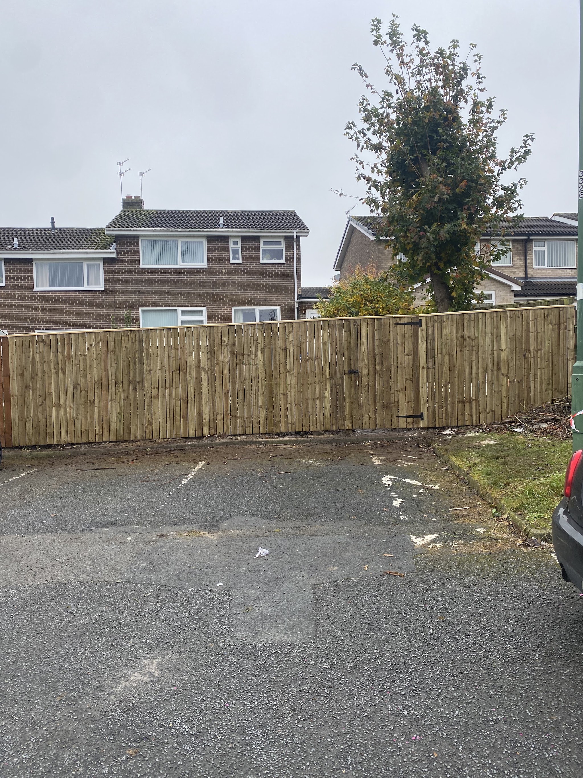 A new close-board fence beside a car park